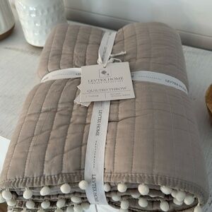 Levtex quilted throw with pom poms